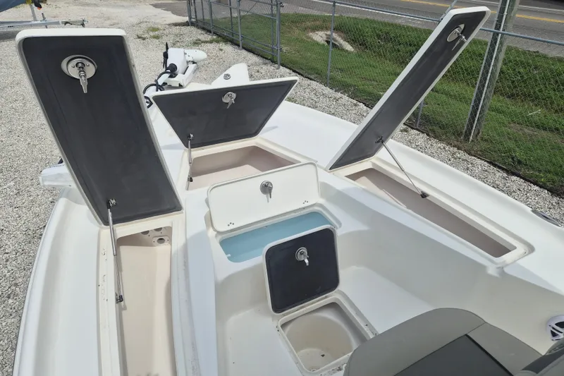Slide: The Image of 2026 Key West 230 Bay Reef boat with open storage compartments and livewell. - 19