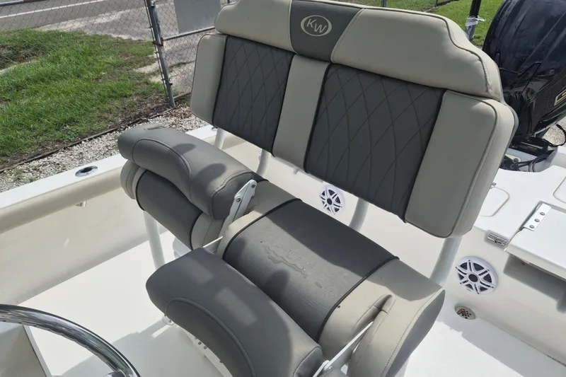 Slide: The Image of 2026 Key West 230 Bay Reef boat seating with gray upholstery and diamond stitching. - 15