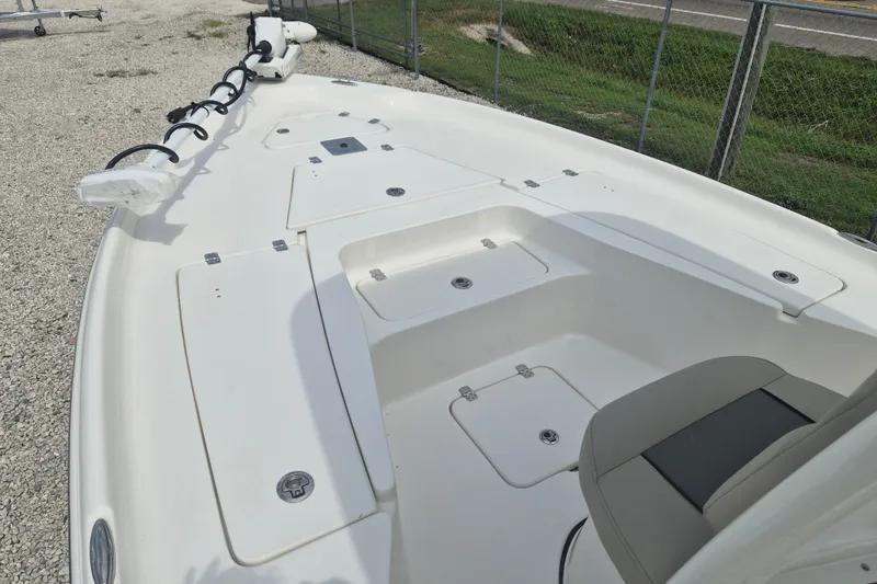 Slide: The Image of 2026 Key West 230 Bay Reef boat deck with storage compartments and seating. - 18