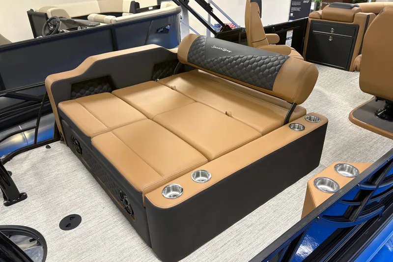 Slide: The Image of Luxurious seating area on 2027 South Bay 525UL boat with tan upholstery and cup holders. - 6
