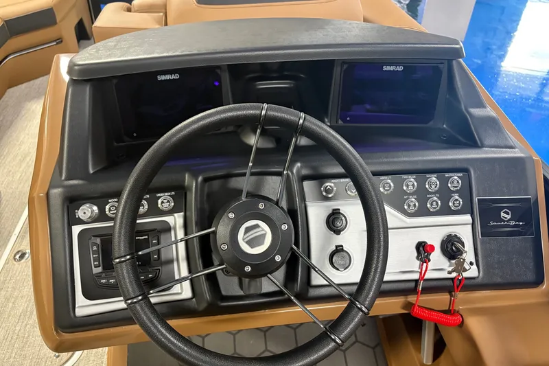 Slide: The Image of Steering console of 2027 South Bay 525UL boat with modern controls and Simrad displays. - 4