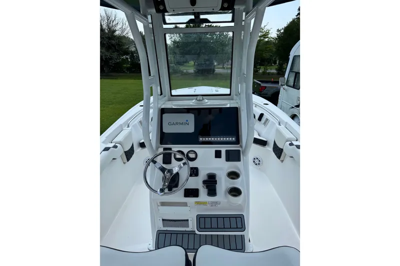 Slide: The Image of 2022 Tidewater 232 LXF boat cockpit with Garmin navigation system and steering wheel. - 6