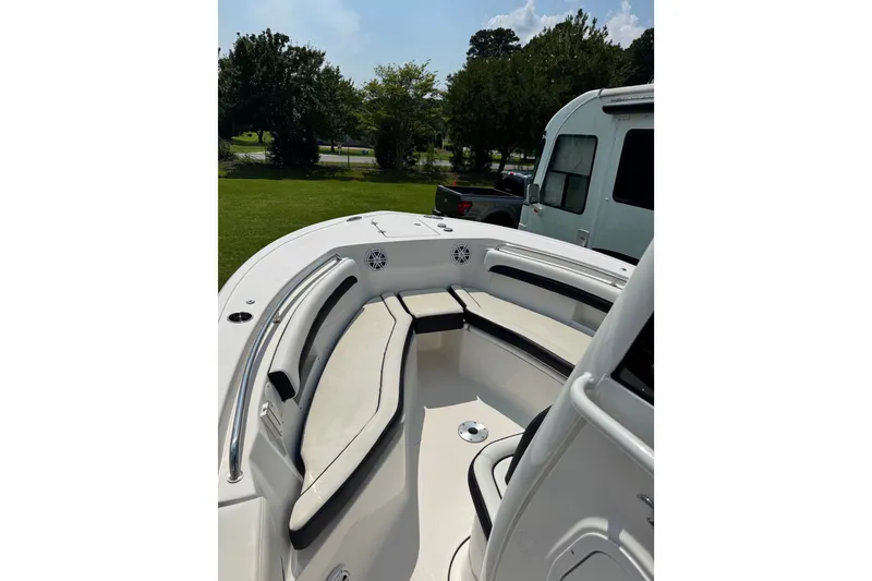 Slide: The Image of 2022 Tidewater 232 LXF boat interior with cushioned seating and sleek design. - 5