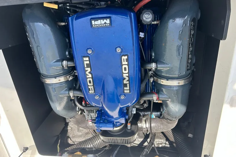 Slide: The Image of 2017 MasterCraft XT23 Ilmor engine, blue and gray components, detailed view. - 12