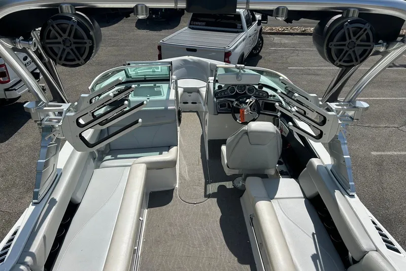 Slide: The Image of 2017 MasterCraft XT23 boat interior with seating, speakers, and steering wheel. - 6