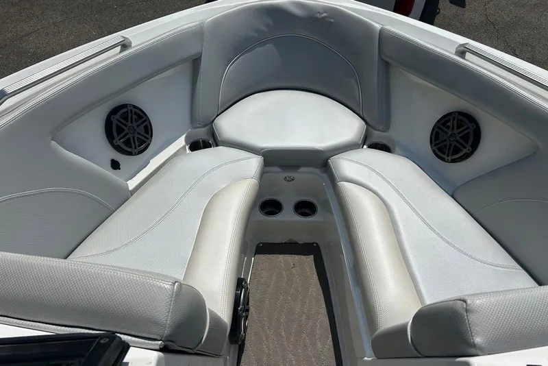 Slide: The Image of Interior of a 2017 MasterCraft XT23 boat, featuring cushioned seating and built-in speakers. - 11