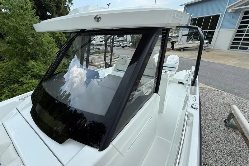 Slide: The Image of A modern Wellcraft 28 T-Top boat with sleek design and spacious deck, ideal for outings. - 15