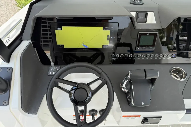 Slide: The Image of The image shows the dashboard of a Wellcraft 28 T-Top boat with a modern navigation system. - 17