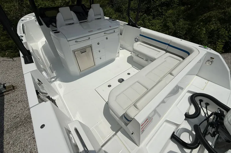 Slide: The Image of The image shows the cockpit of a Wellcraft 28 T-Top boat with white seating and storage. - 25