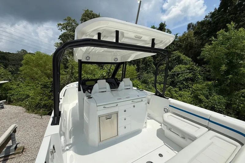 Slide: The Image of The image shows a 2026 Wellcraft 28 T-Top boat with a white deck and black T-top. - 23
