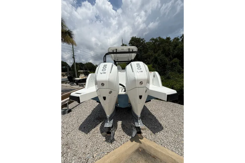 Slide: The Image of The image shows the rear of a Wellcraft 28 T-Top boat with two powerful outboard engines. - 2
