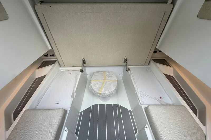 Slide: The Image of Interior of a 2026 Wellcraft 28 T-Top with seating benches and a central table. - 14