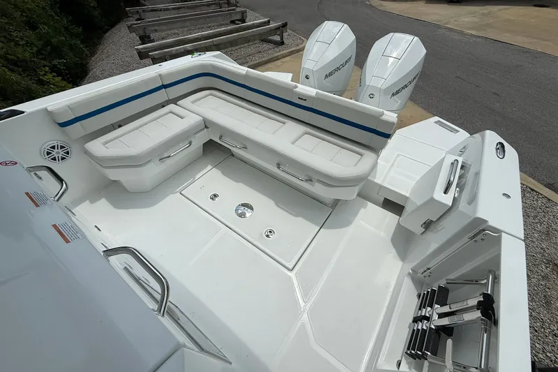Slide: The Image of The image shows the spacious aft deck of a Wellcraft 28 T-Top with white cushioned seating. - 24
