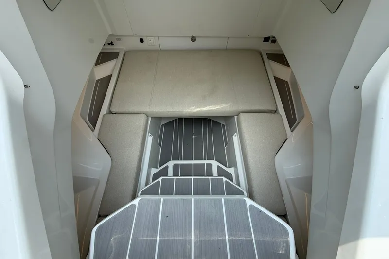 Slide: The Image of Interior of a modern cabin with gray upholstery and textured flooring. - 13