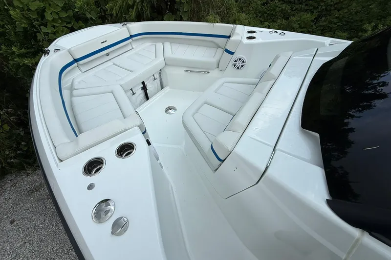 Slide: The Image of The image shows the cockpit of a 2026 Wellcraft 28 T-Top boat with white upholstery. - 7