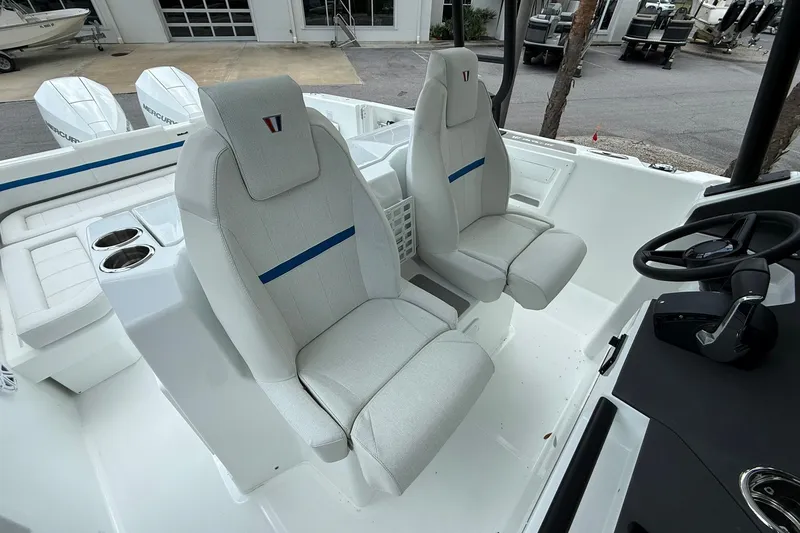 Slide: The Image of The image shows the interior of a 2026 Wellcraft 28 T-Top boat with two cushioned seats. - 19
