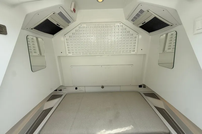 Slide: The Image of Interior of a modern boat cabin with a cushioned bed and mirrors on the sides. - 12