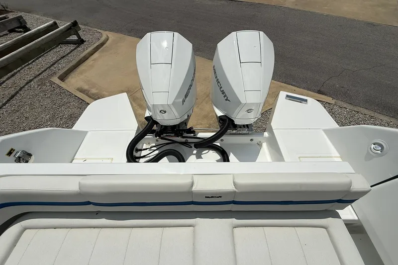 Slide: The Image of The image shows the stern of a Wellcraft 28 T-Top boat with two Mercury outboard engines. - 26