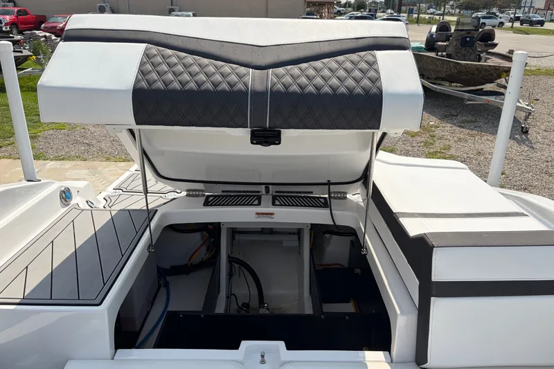 Slide: The Image of 2024 Monterey 215SS Super Sport boat with open engine compartment, showcasing sleek design. - 22