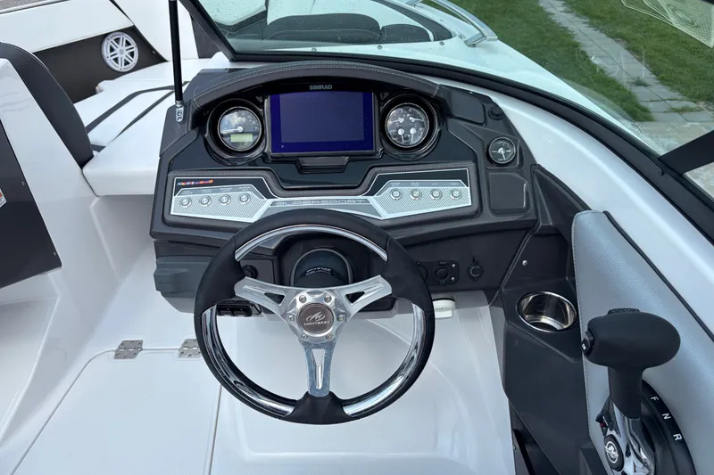 Slide: The Image of 2024 Monterey 215SS Super Sport boat dashboard with steering wheel and control panel. - 17