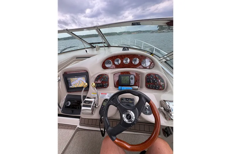Slide: The Image of Cockpit view of 2006 Sea Ray 340 Sundancer boat with navigation instruments and steering wheel. - 19