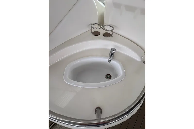 Slide: The Image of 2006 Sea Ray 340 Sundancer boat sink with faucet and cup holders. - 17