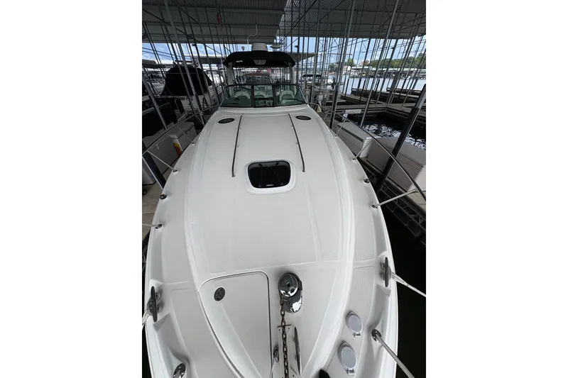 Slide: The Image of 2006 Sea Ray 340 Sundancer yacht docked in a marina, showcasing sleek design and spacious deck. - 37