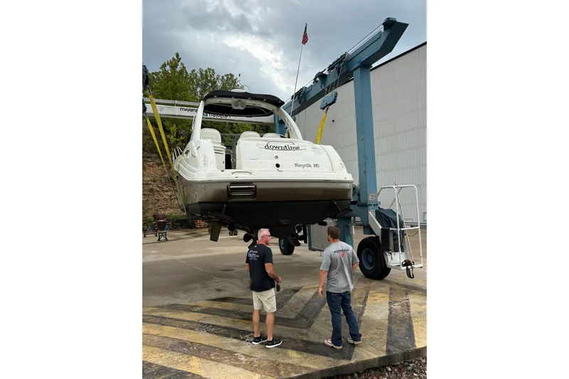 Slide: The Image of 2006 Sea Ray 340 Sundancer being lifted by a crane at a marina. - 40