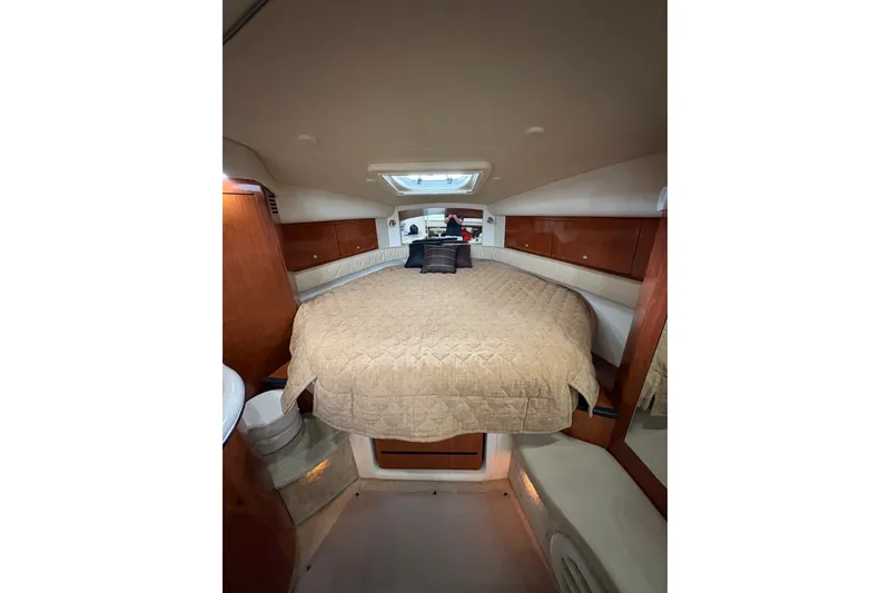 Slide: The Image of Luxurious cabin interior of 2006 Sea Ray 340 Sundancer with cozy bedding and wood accents. - 28