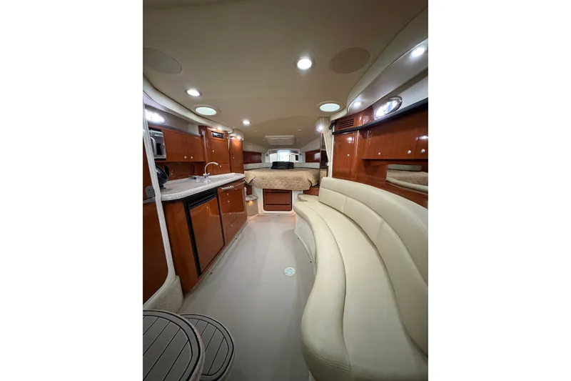 Slide: The Image of Interior of 2006 Sea Ray 340 Sundancer yacht with elegant seating and wood cabinetry. - 24
