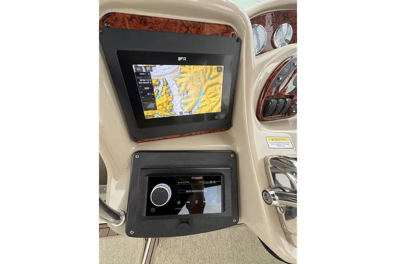 Slide: The Image of Dashboard of a 2006 Sea Ray 340 Sundancer with navigation and audio controls. - 20