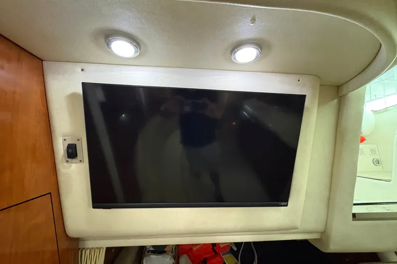 Slide: The Image of Flat-screen TV in 2006 Sea Ray 340 Sundancer cabin, illuminated by overhead lights. - 27