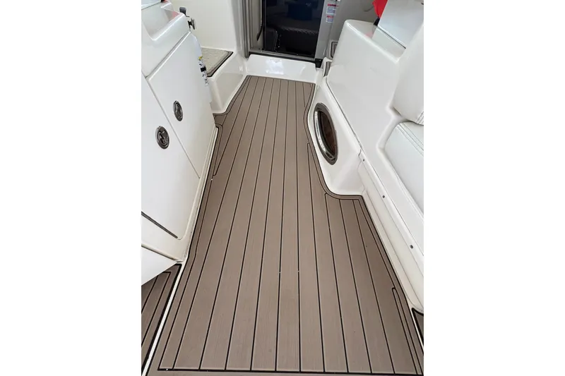 Slide: The Image of 2006 Sea Ray 340 Sundancer boat interior with sleek, modern flooring and white seating. - 14
