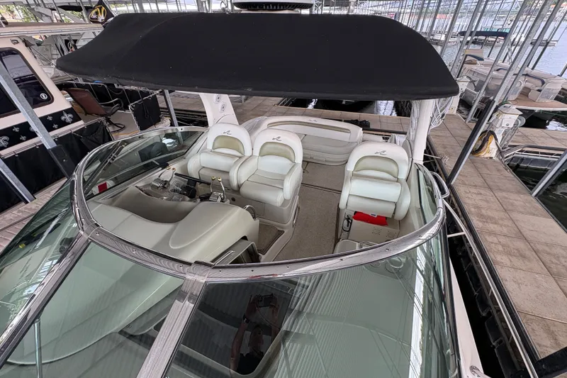 Slide: The Image of 2006 Sea Ray 340 Sundancer boat interior with helm and seating under canopy. - 38