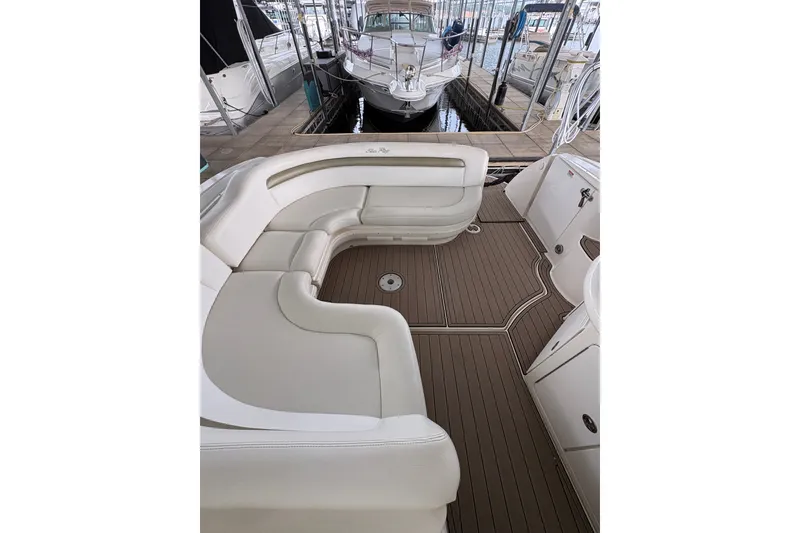 Slide: The Image of Luxurious 2006 Sea Ray 340 Sundancer boat interior with elegant seating and wood-style flooring. - 13