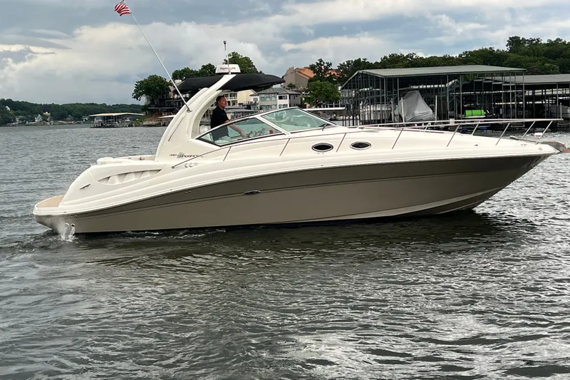 The Image of 2006 Sea Ray 340 Sundancer cruising on a lake with marina in the background. - 0
