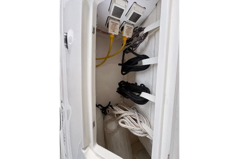 Slide: The Image of Storage compartment with ropes and cables on a 2006 Sea Ray 340 Sundancer boat. - 16