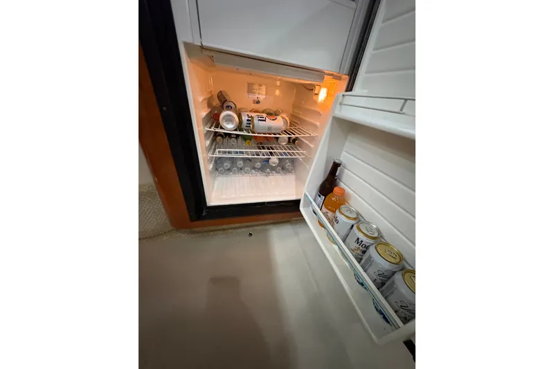 Slide: The Image of Open fridge on 2006 Sea Ray 340 Sundancer, stocked with beverages and snacks. - 30