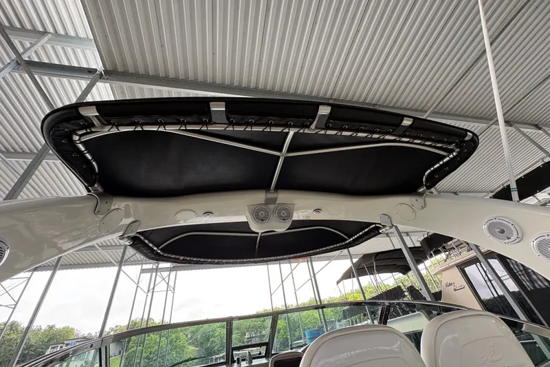 Slide: The Image of 2006 Sea Ray 340 Sundancer boat canopy and seating under a metal roof. - 22