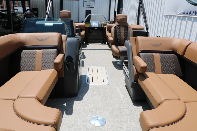 Slide: The Image of 2026 Bennington 22MFB pontoon boat interior with luxurious tan and brown seating. - 23
