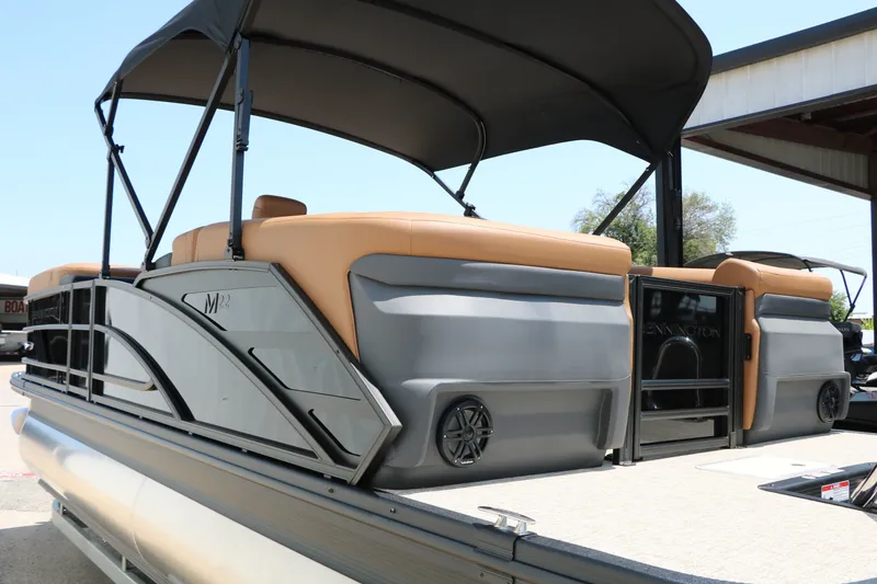 Slide: The Image of 2026 Bennington 22MFB pontoon boat with tan seating and black canopy. - 21