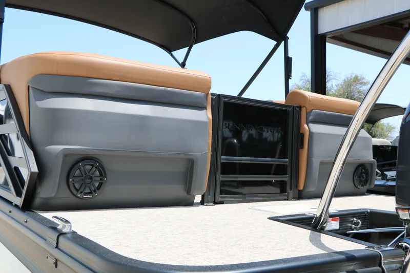 Slide: The Image of 2026 Bennington 22MFB boat interior with tan seating and speaker system. - 19
