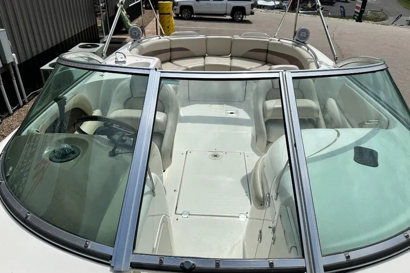 Slide: The Image of 2005 Chaparral Sunesta 274 boat interior with seating and steering wheel. - 12