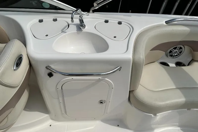 Slide: The Image of 2005 Chaparral Sunesta 274 boat interior with sink and seating area. - 7