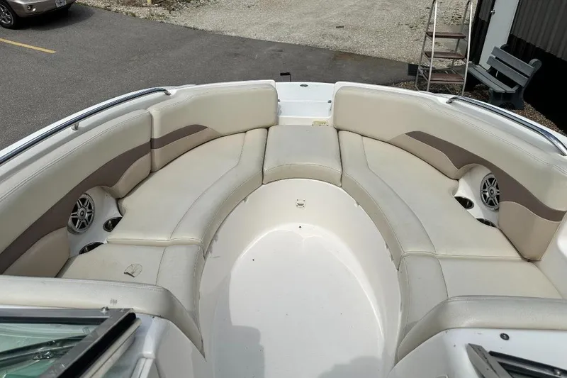Slide: The Image of 2005 Chaparral Sunesta 274 boat interior with beige seating and built-in speakers. - 11