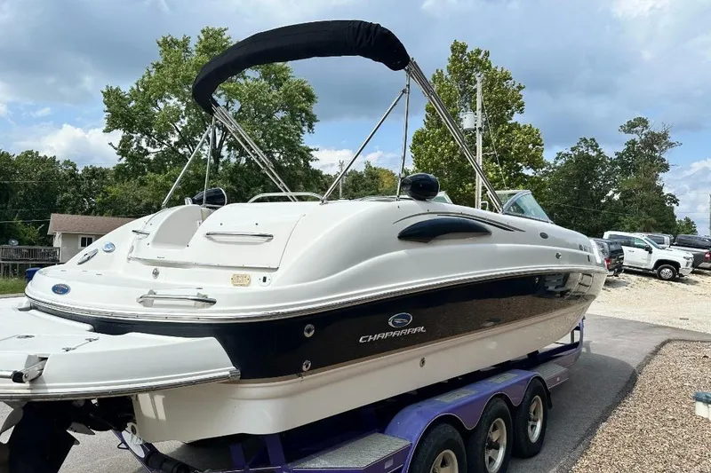 Slide: The Image of 2005 Chaparral Sunesta 274 boat on trailer, parked outdoors under cloudy sky. - 3