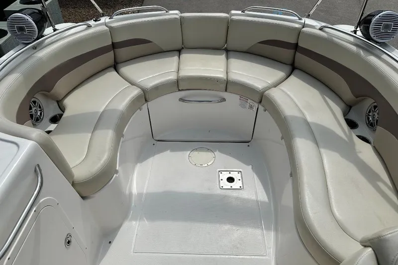 Slide: The Image of 2005 Chaparral Sunesta 274 boat interior with curved seating and speakers. - 6