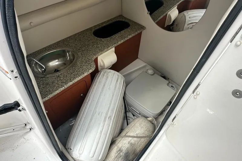 Slide: The Image of Interior of a 2005 Chaparral Sunesta 274 boat with sink and portable toilet. - 14