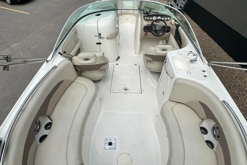 Slide: The Image of 2005 Chaparral Sunesta 274 boat interior with seating, steering wheel, and dashboard. - 4