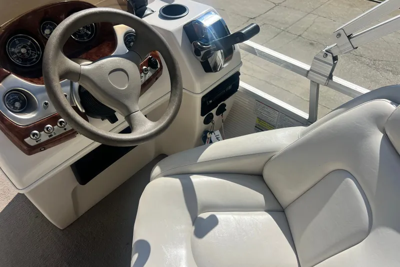 Slide: The Image of 2006 Princecraft Versailles 22 LP-SS boat cockpit with steering wheel and controls. - 6